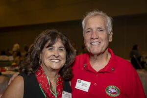 A man and woman smile for the camera.