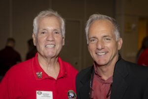 Two men smiling for a picture at an event.