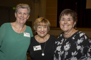 Three women are posing for a picture.