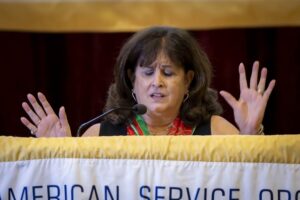 A woman is speaking at an african service conference.