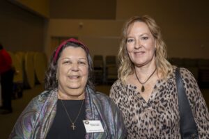 Two women standing next to each other in a room.
