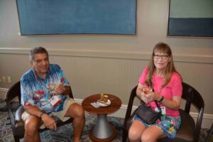 Two people sitting at a table with food.