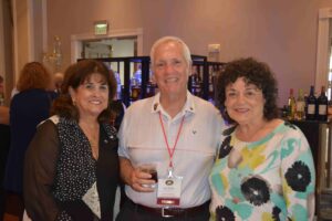 Three people posing for a picture at an event.