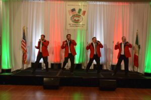 A group of men in red jackets on stage.