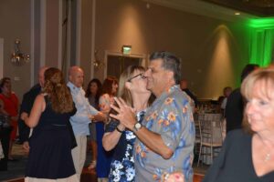 A man and woman dancing in front of a crowd.