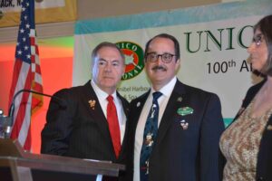 Two men in suits and ties standing next to each other.
