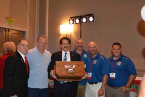 A group of men standing around each other.