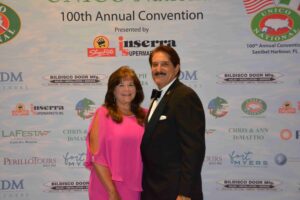 A man and woman posing for a picture at an event.