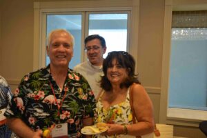 A group of people standing around in front of windows.