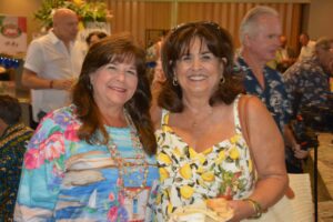 Two women standing next to each other in a room.
